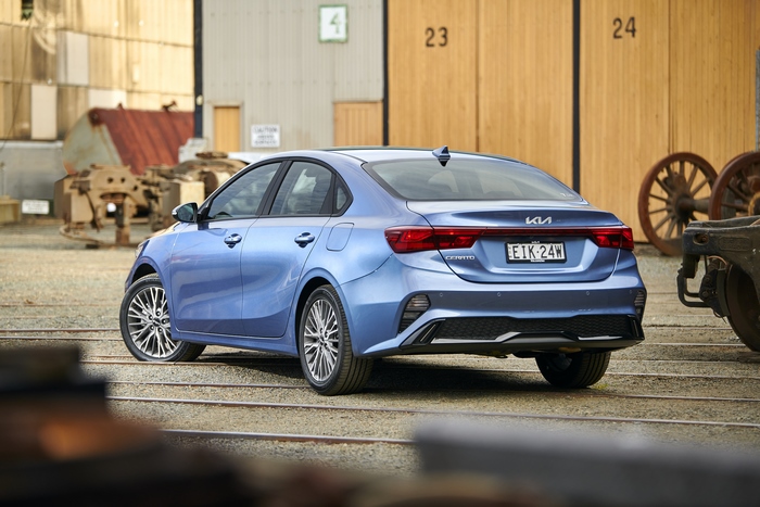 Blue Kia Cerato Sport Plus in industrial setting