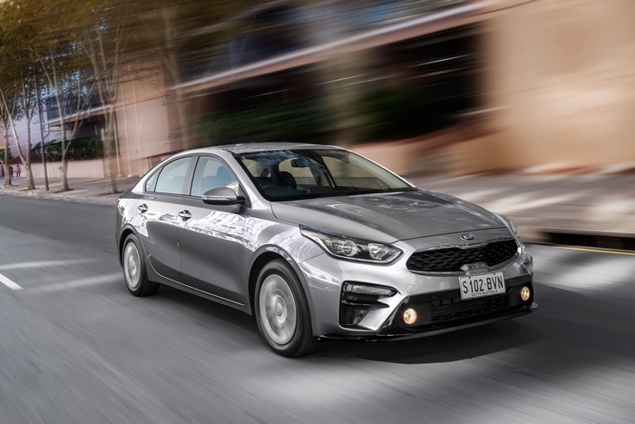 Silver Kia Cerato S compact car driving on street