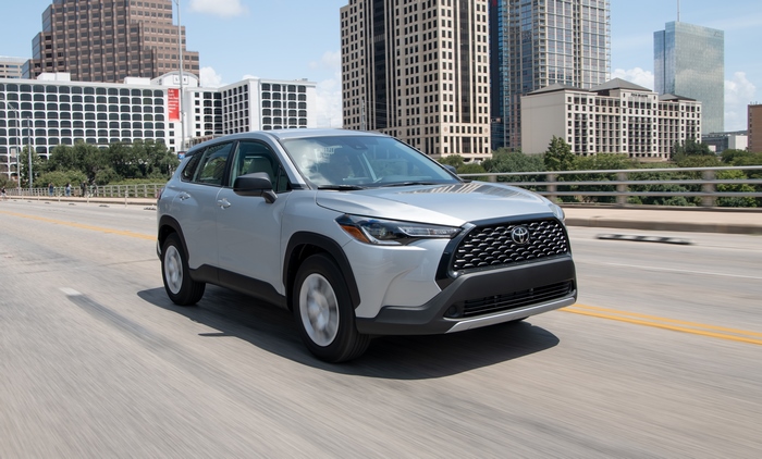 Silver Toyota Corolla Cross SUV driving in city