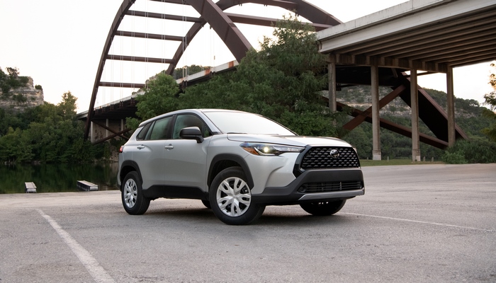 Toyota Corolla Cross SUV parked by a scenic bridge