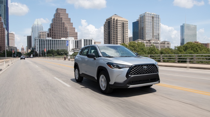 Toyota Corolla Cross SUV driving on Austin bridge