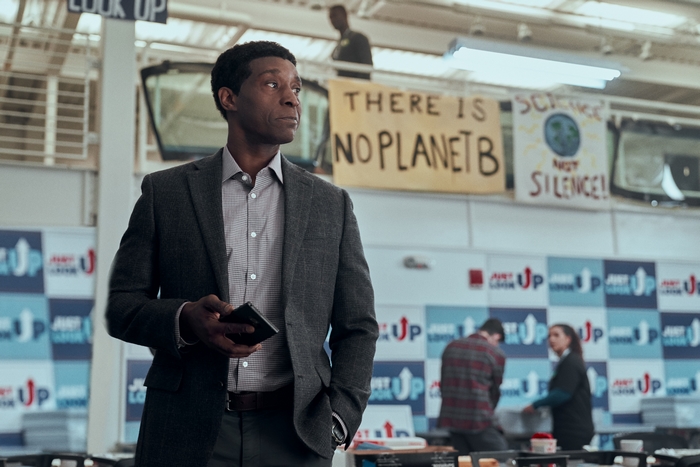 Rob Morgan in Don't Look Up with 'No Planet B' sign