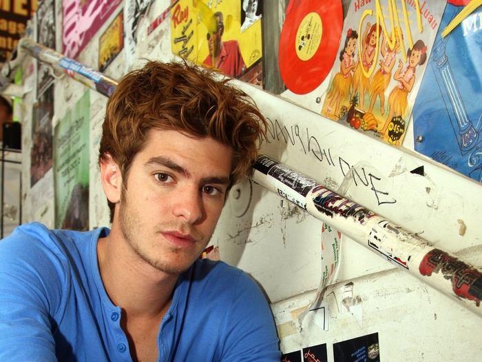 Andrew Garfield posing in blue shirt indoors