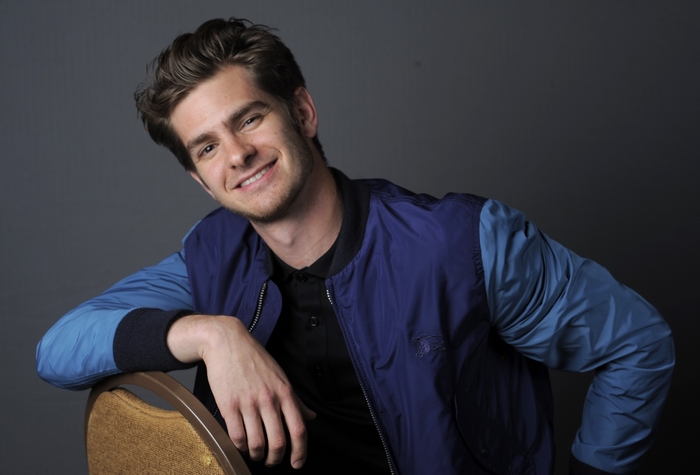 Andrew Garfield smiling in a two-tone blue jacket