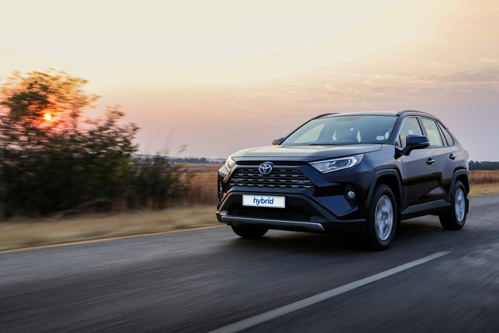 Toyota RAV4 Hybrid SUV Driving on Road at Sunset