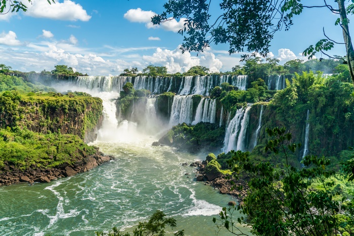 Majestic waterfalls in a vibrant green tropical landscape