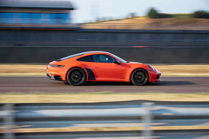 Orange Porsche 911 Carrera GTS on race track