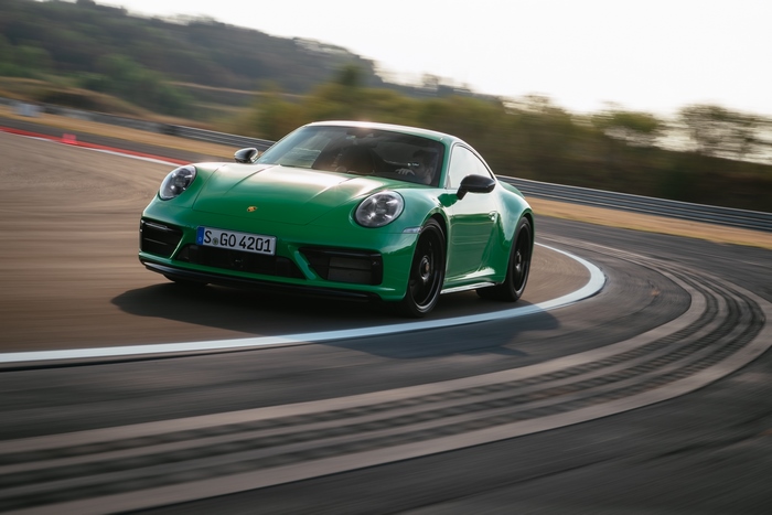 Green Porsche 911 Carrera GTS cornering on track