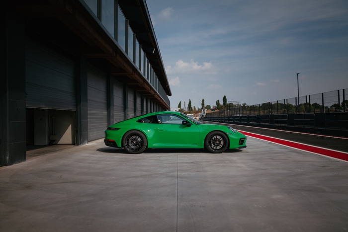 Green Porsche 911 Carrera GTS at the track