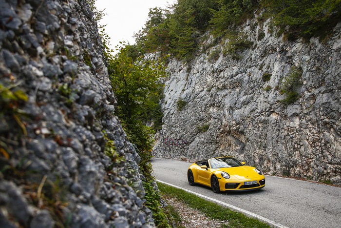 Yellow Porsche 911 Cabriolet on a winding mountain road