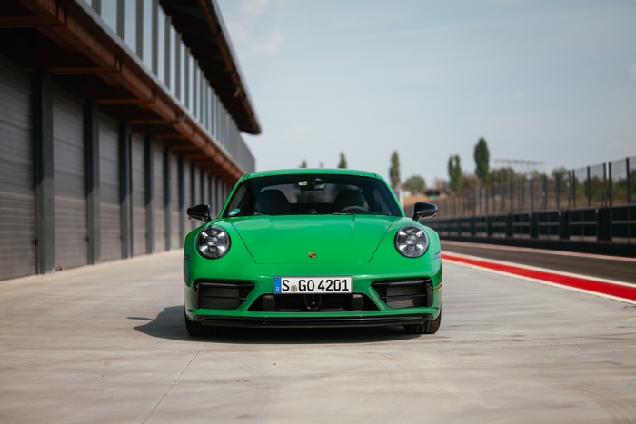 Green Porsche 911 Carrera GTS sport car on track