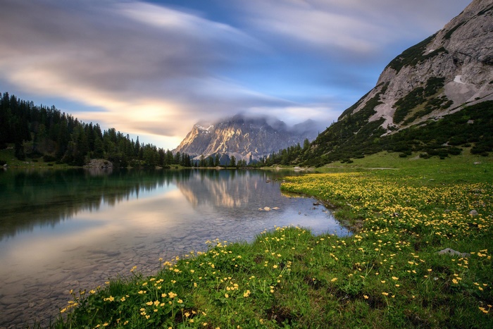 Beautiful Mountain Lake with Yellow Flowers and Reflection