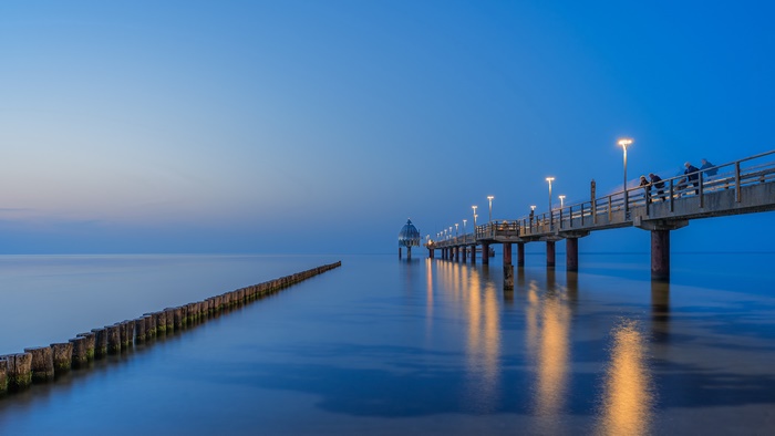 Illuminated Pier with Dome and Reflections at Twilight