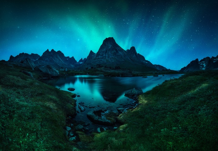 Aurora Borealis over Fjord Mountains at Night