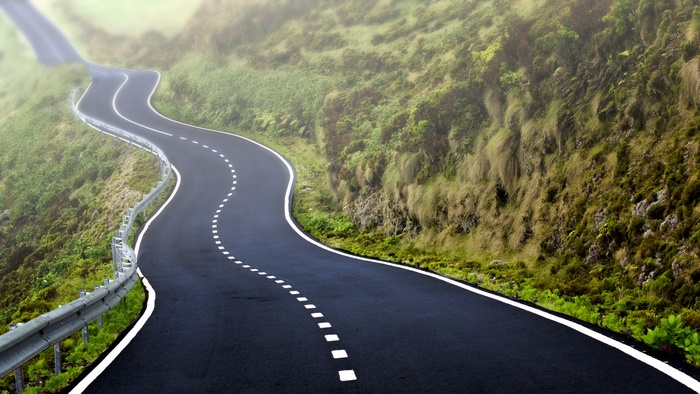 Winding Mountain Road Through Green Hills