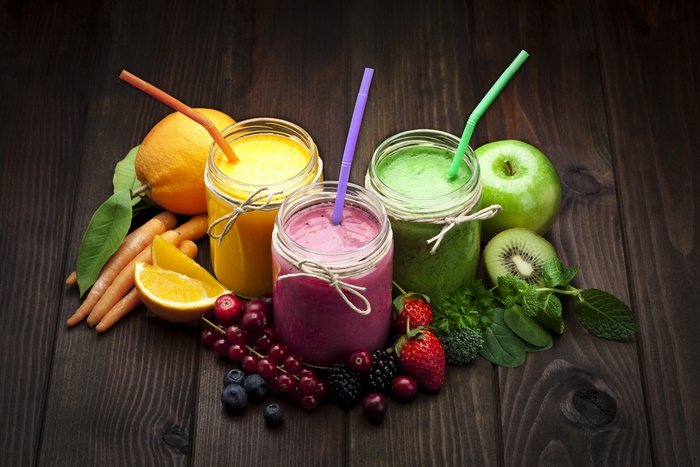 Colorful smoothies and fresh ingredients on dark wood 4K