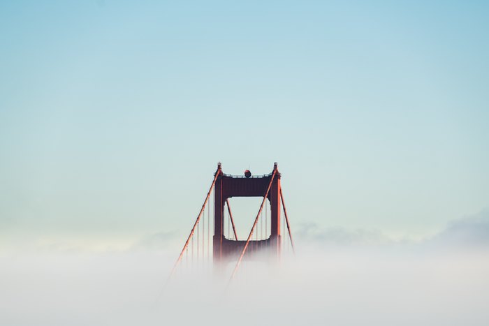 Golden Gate Bridge tower emerging from the fog