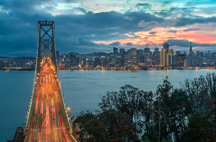 San Francisco Bay Bridge and city skyline at sunset