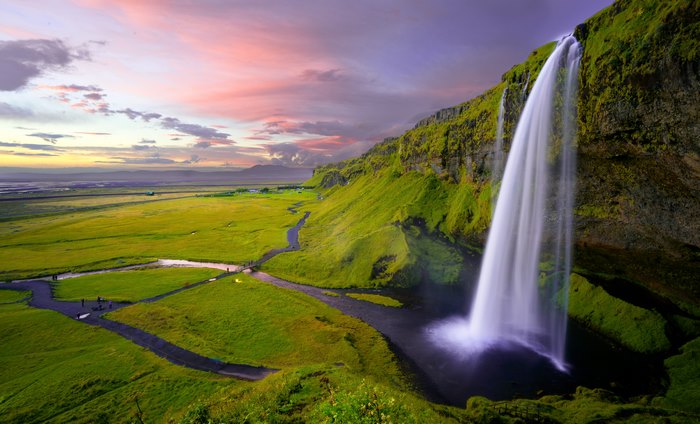 Majestic Waterfall and Idyllic Green Landscape at Dusk