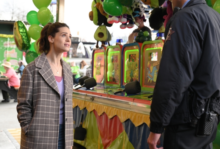 Lyndsy Fonseca looks concerned at carnival game booth