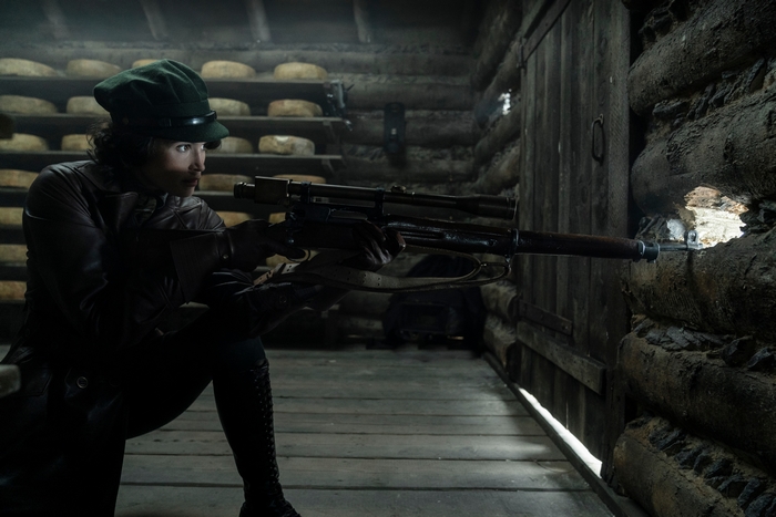 Gemma Arterton aiming rifle in The King's Man