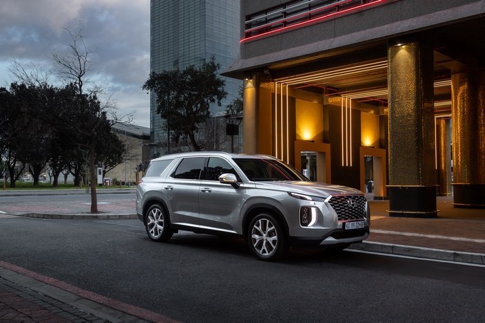 Hyundai Palisade SUV parked by modern building