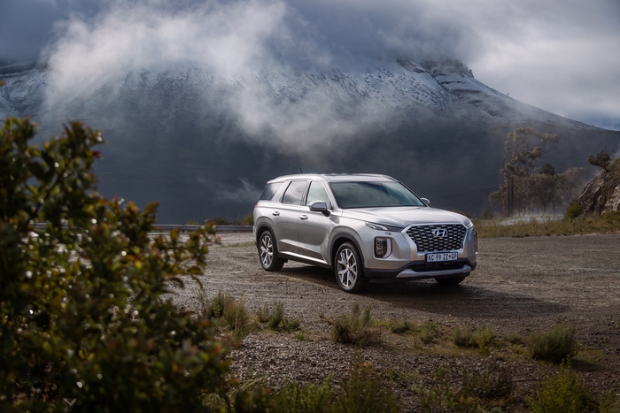 Silver Hyundai Palisade SUV with majestic snowy mountains