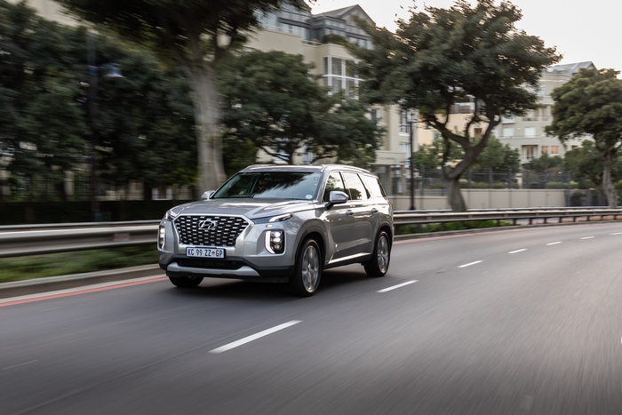 Silver Hyundai Palisade SUV driving on road