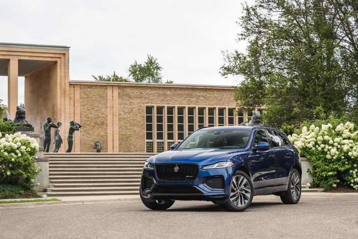 Blue Jaguar F-Pace SUV in front of a building