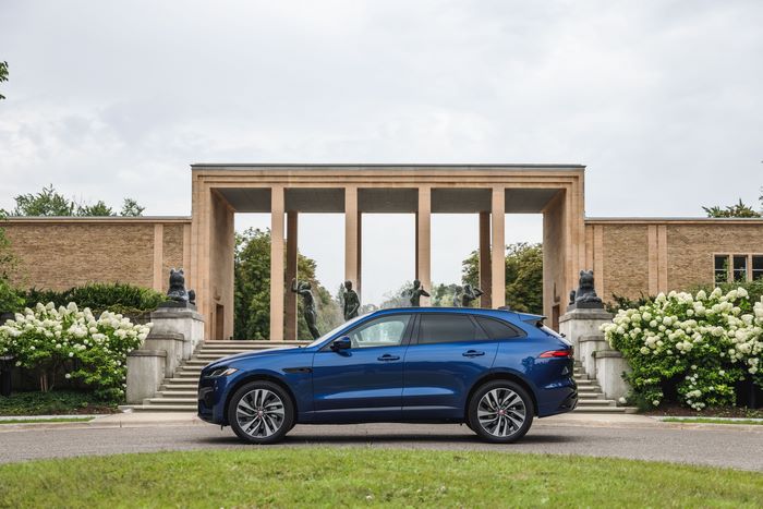 Blue Jaguar F-Pace SUV at a grand building