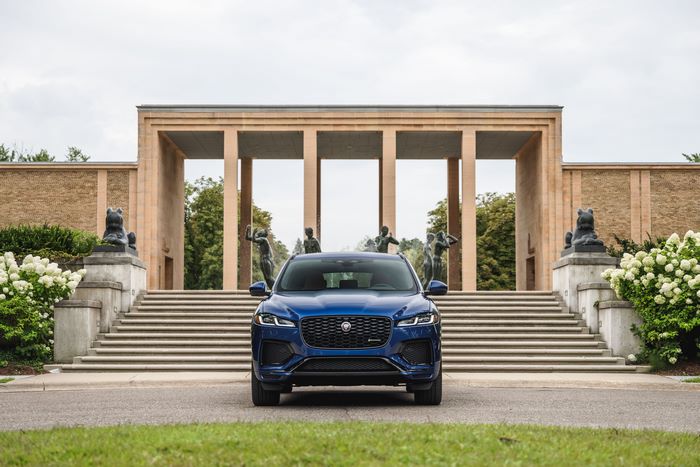 Blue Jaguar F-Pace SUV in front of a grand building
