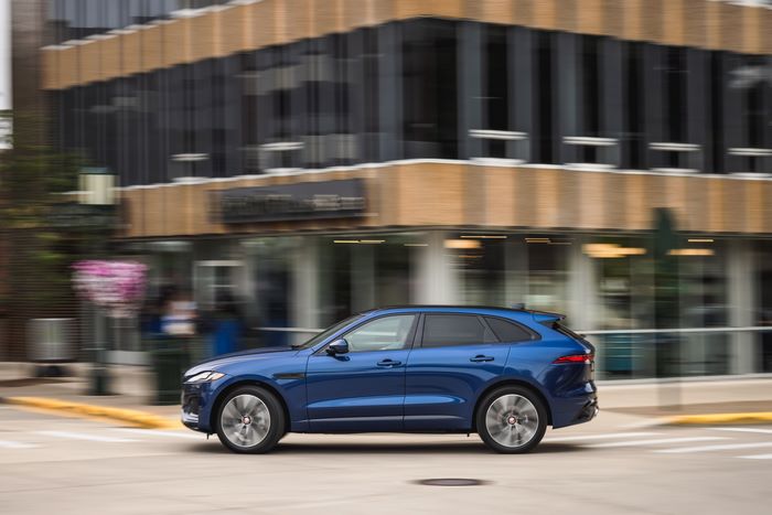 Blue Jaguar F-Pace SUV driving in city