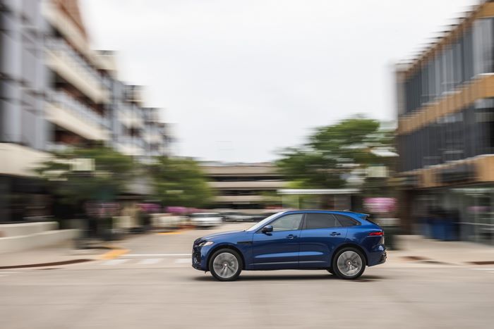 Blue Jaguar F-Pace SUV driving