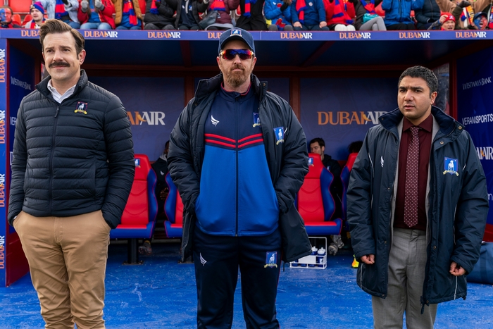 Ted Lasso, Coach Beard, and Nate in football dugout