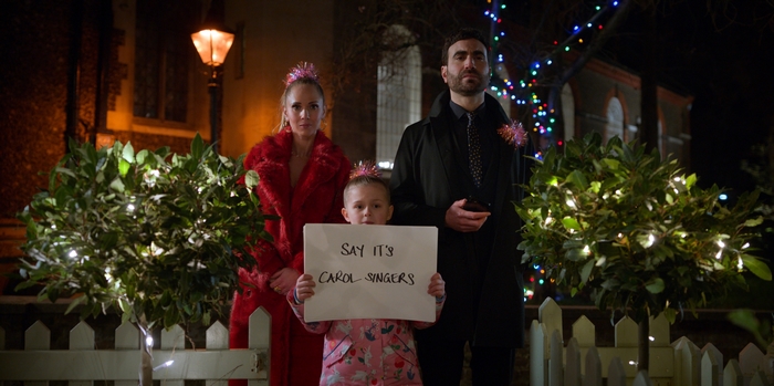 Ted Lasso: Roy, Keeley, and Phoebe as carol singers