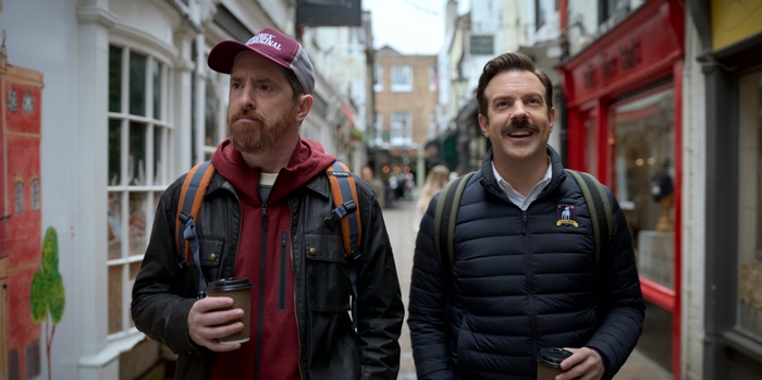 Ted Lasso and Coach Beard walking with coffee
