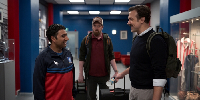 Ted Lasso, Coach Beard, and Nathan with luggage