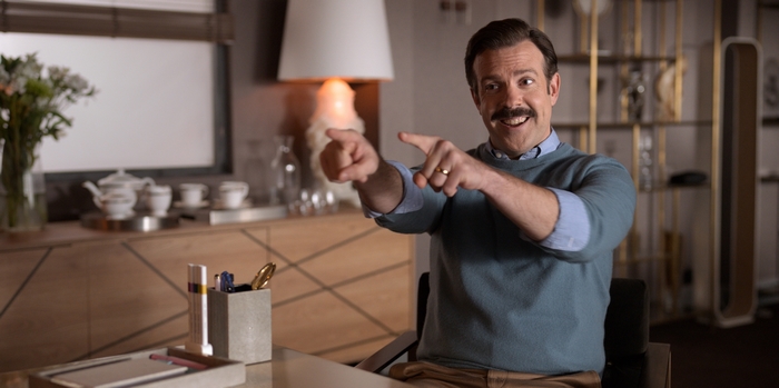Ted Lasso smiling and pointing at the viewer