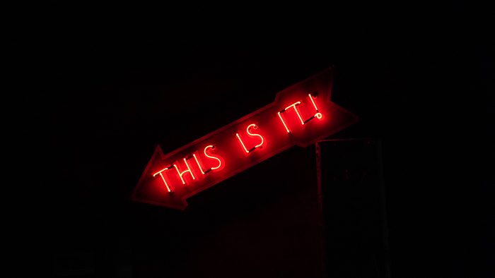 Glowing red "THIS IS IT!" statement neon sign