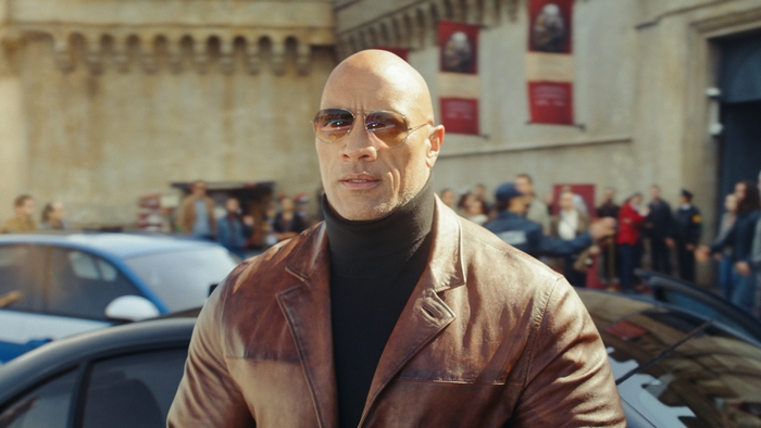 Dwayne Johnson in Red Notice wearing sunglasses and jacket