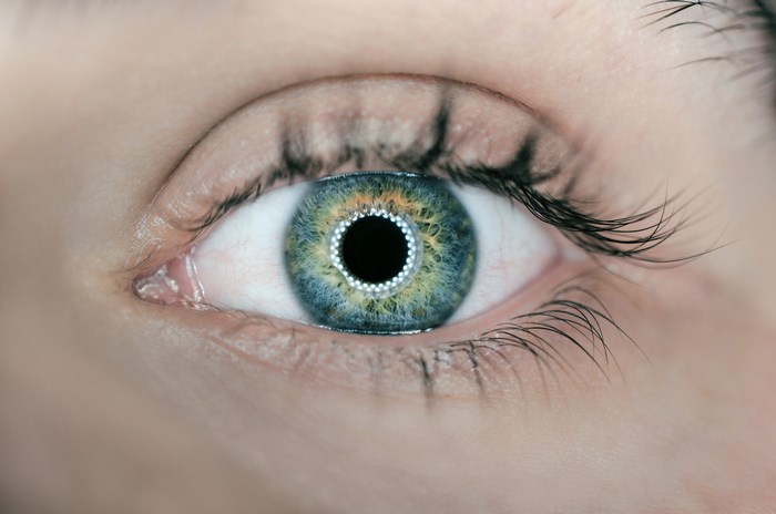 Detailed human eye with blue-green iris and pupil ring 4K