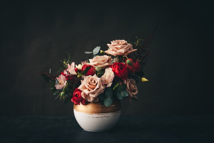 Moody red and peach flower bouquet in vase