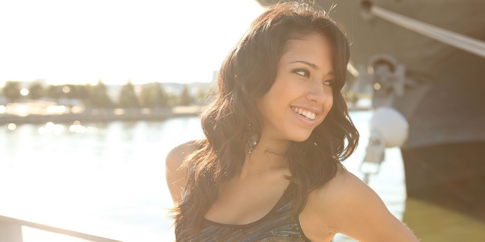 Jasmine Villegas smiling brightly in warm sunlight