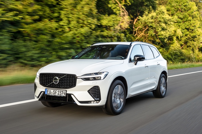 White Volvo XC60 SUV driving on road