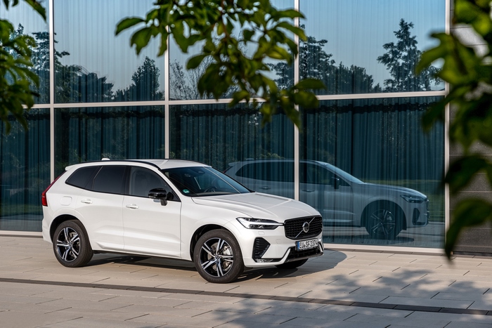White Volvo XC60 B5 R-Design SUV by modern building