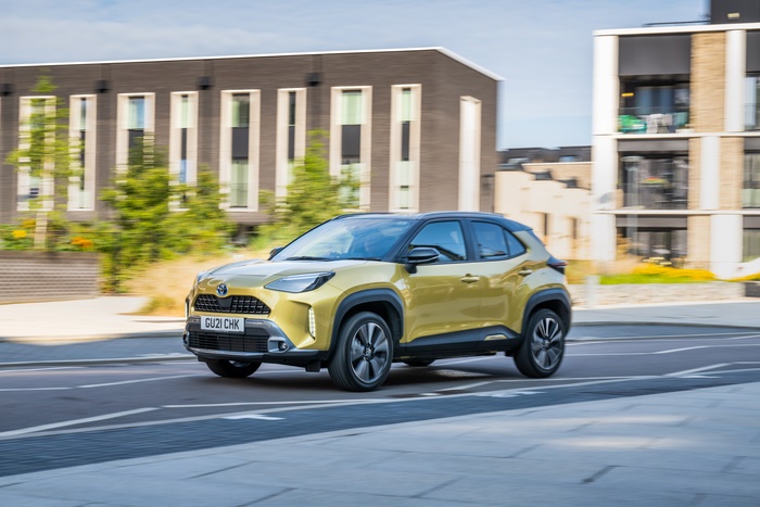 Gold Toyota Yaris Cross Hybrid SUV in motion 4K
