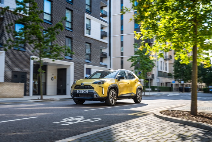 4K Yellow Toyota Yaris Cross Hybrid SUV on urban street