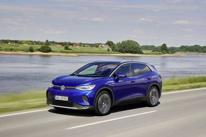 Blue Volkswagen ID.4 Electric Car Driving by a River