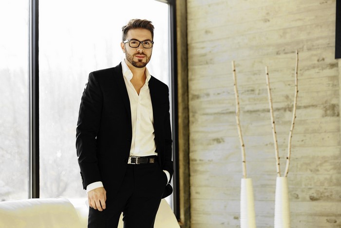 Danny Gokey in a black suit and glasses