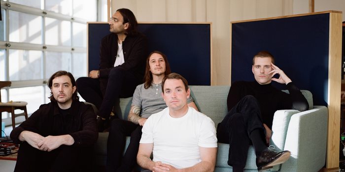 Deafheaven band members posing indoors